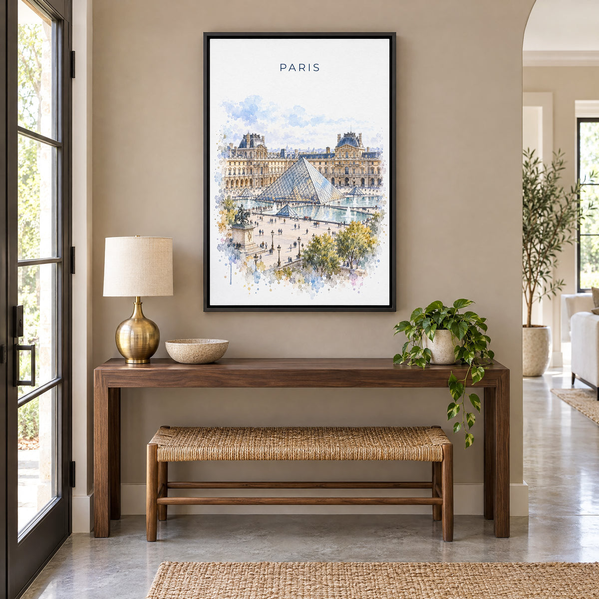 Louvre watercolor print as a black floater canvas above a walnut console and woven bench in an entryway