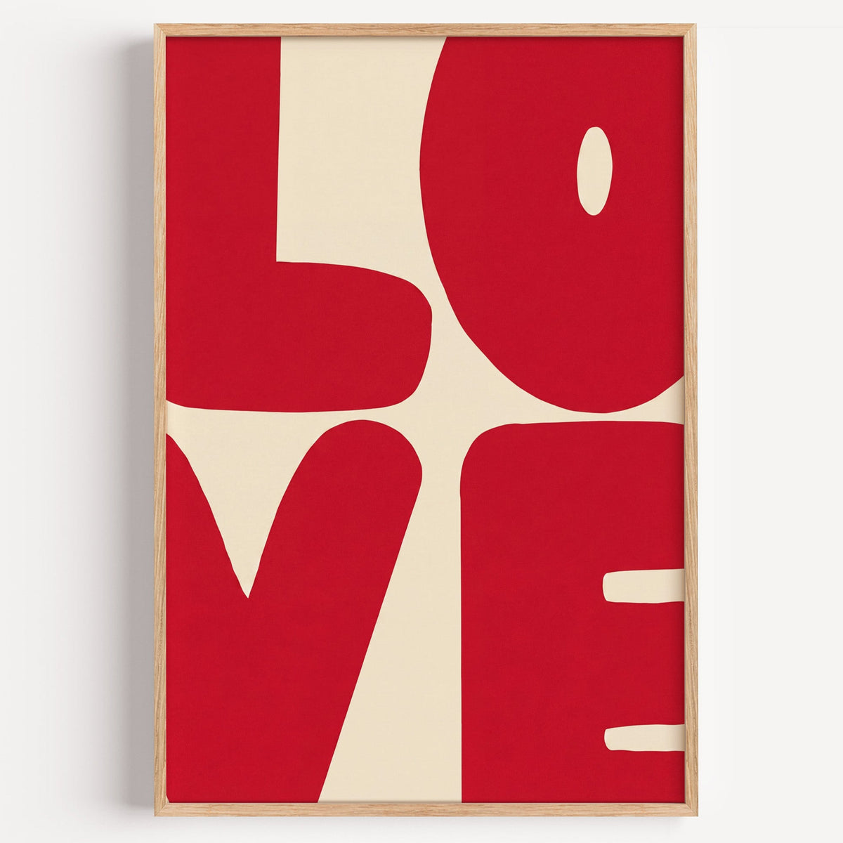 LOVE red block letters print in a light oak frame on a plain white wall