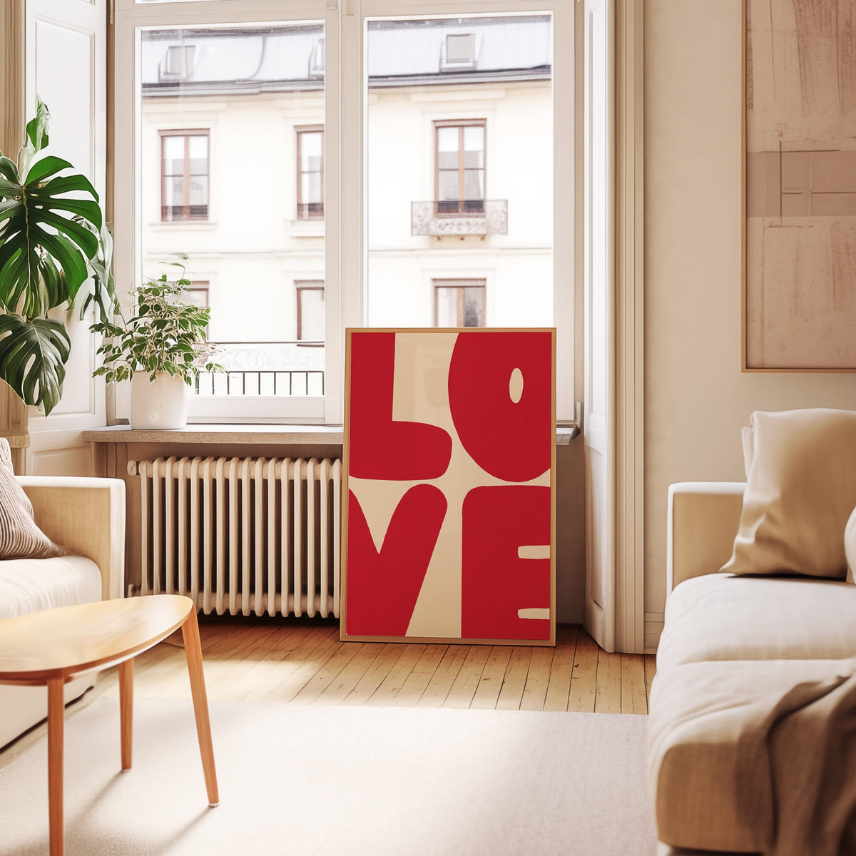 Pop art LOVE print in an oak frame leaning below tall French windows
