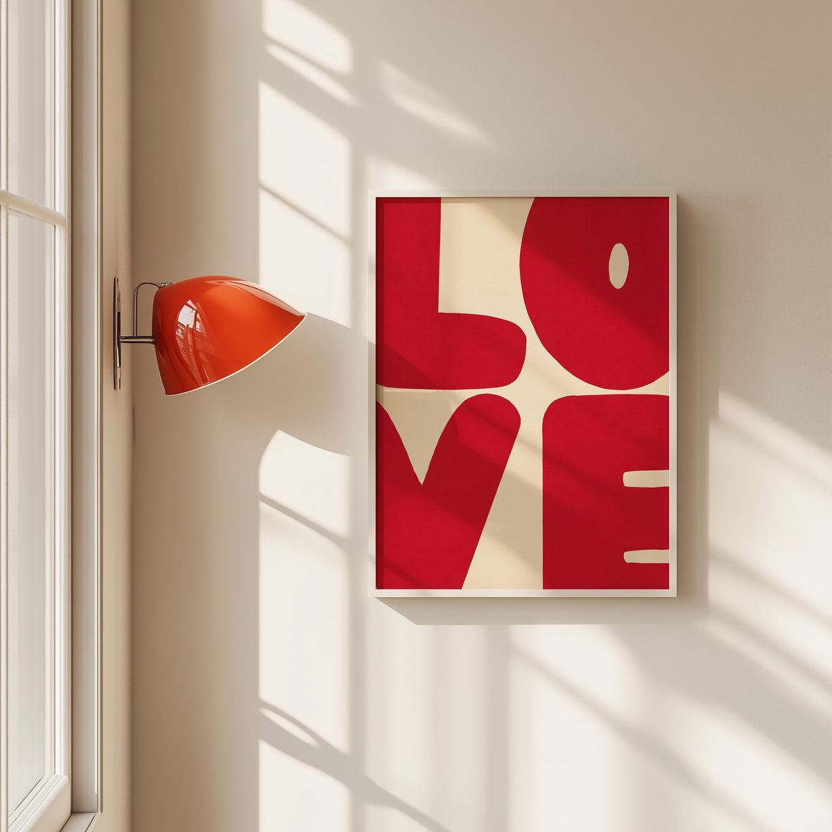 LOVE red block letters print in a white frame beside a red wall sconce