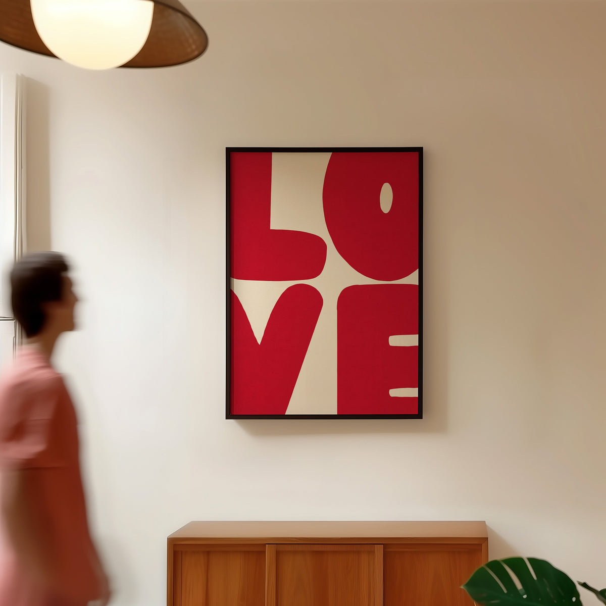 LOVE word art print in a black frame in a hallway under a rattan pendant