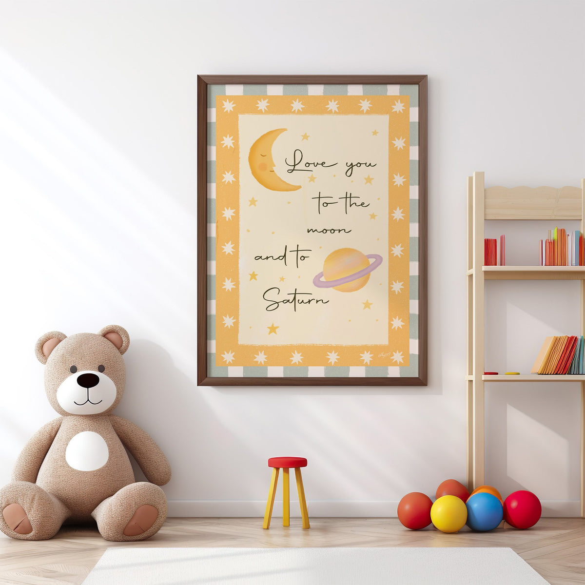 Love you moon and saturn nursery print in a walnut frame above a big teddy bear by a bookshelf