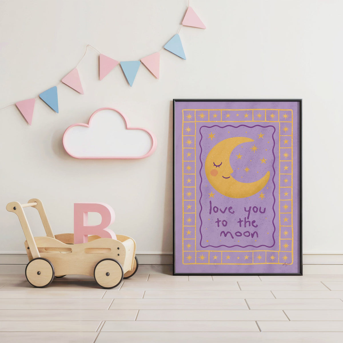 Lavender love you to the moon nursery print in a black frame under pastel bunting by a wooden baby walker