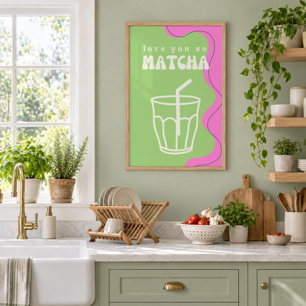 Love you so MATCHA outline glass print in an oak frame on a sage green kitchen wall beside a farmhouse sink and herbs