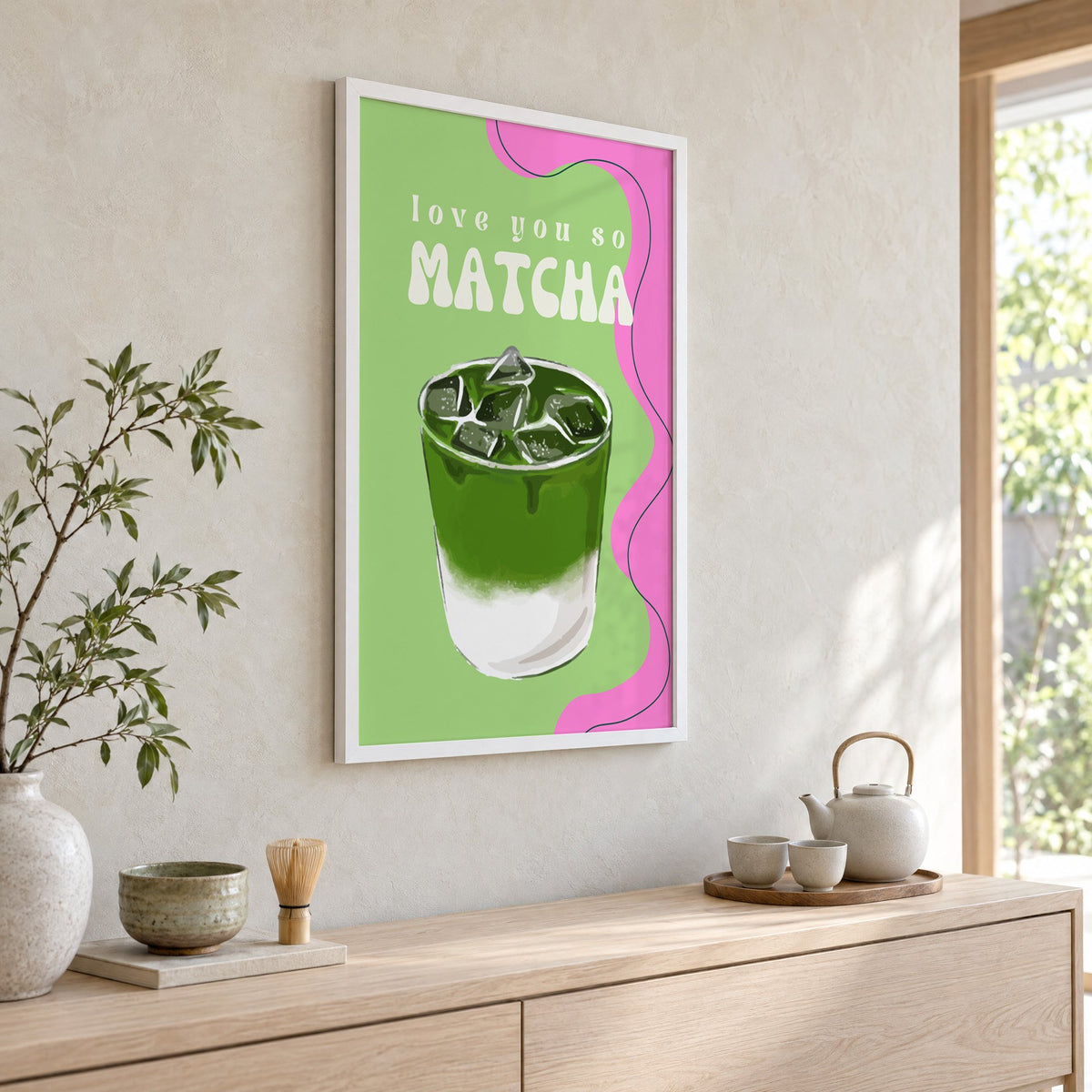 Love you so MATCHA iced latte print in a white frame above a pale wood console with a matcha tea set
