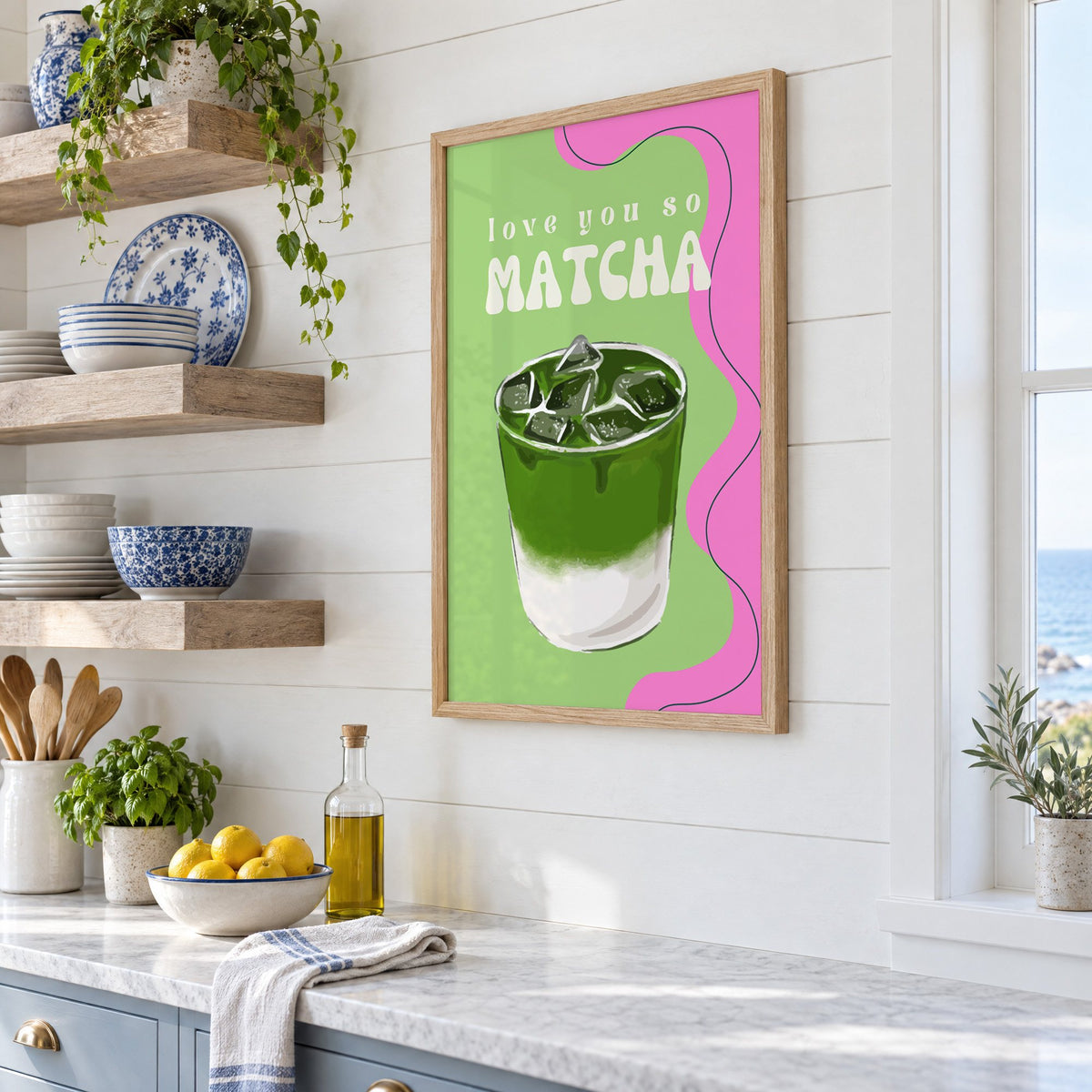 Love you so MATCHA iced latte print in an oak frame in a white coastal kitchen beside blue and white plates