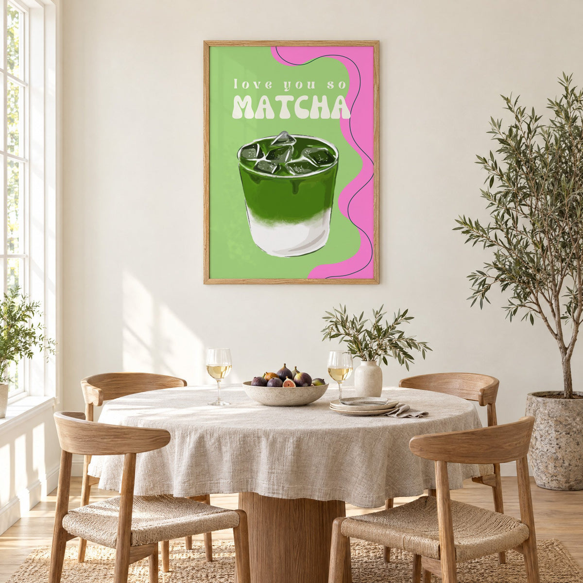 Love you so MATCHA iced latte print in an oak frame above a round linen-covered dining table with figs and wine