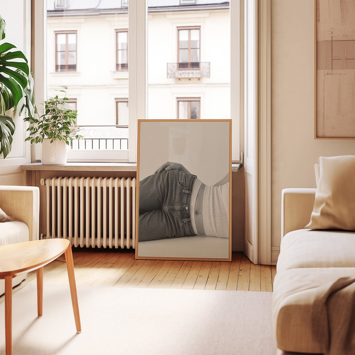 Woman lying in low rise jeans on grey print in an oak frame leaning by a French window in a living room