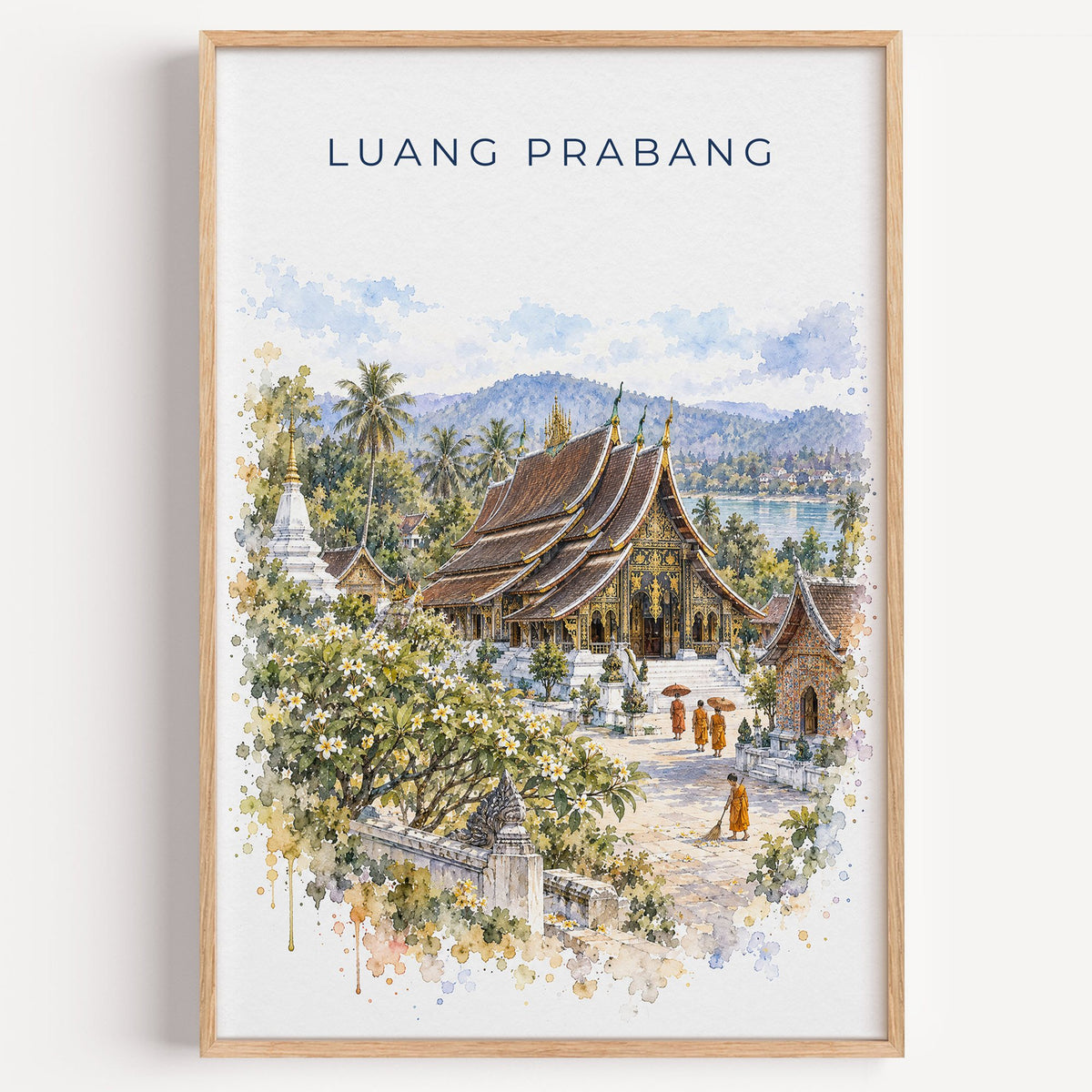 Luang Prabang watercolor print in a light oak frame on a plain white wall