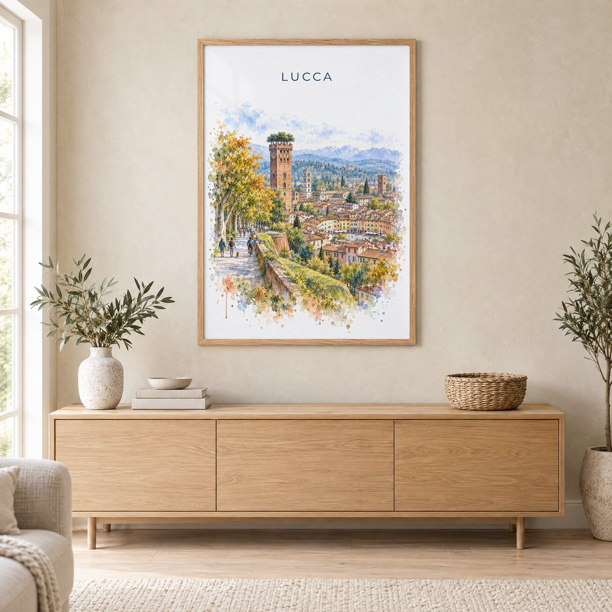 Lucca watercolor print in an oak frame above a light wood sideboard in a Scandinavian living room