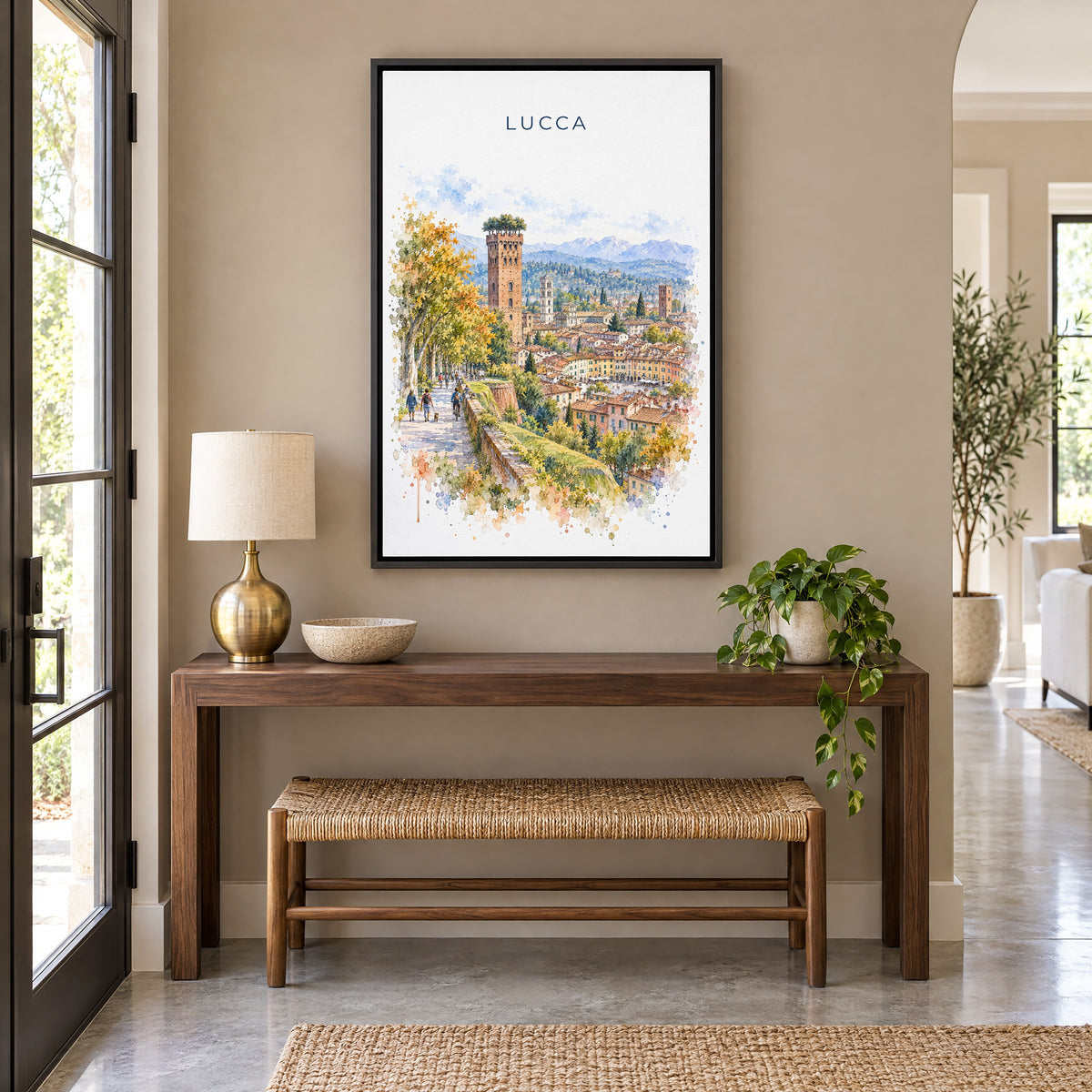 Lucca watercolor print as a black floater canvas above a walnut console and woven bench in an entryway