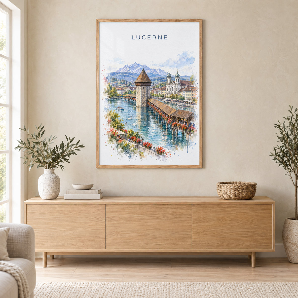 Lucerne watercolor print in an oak frame above a light wood sideboard in a Scandinavian living room