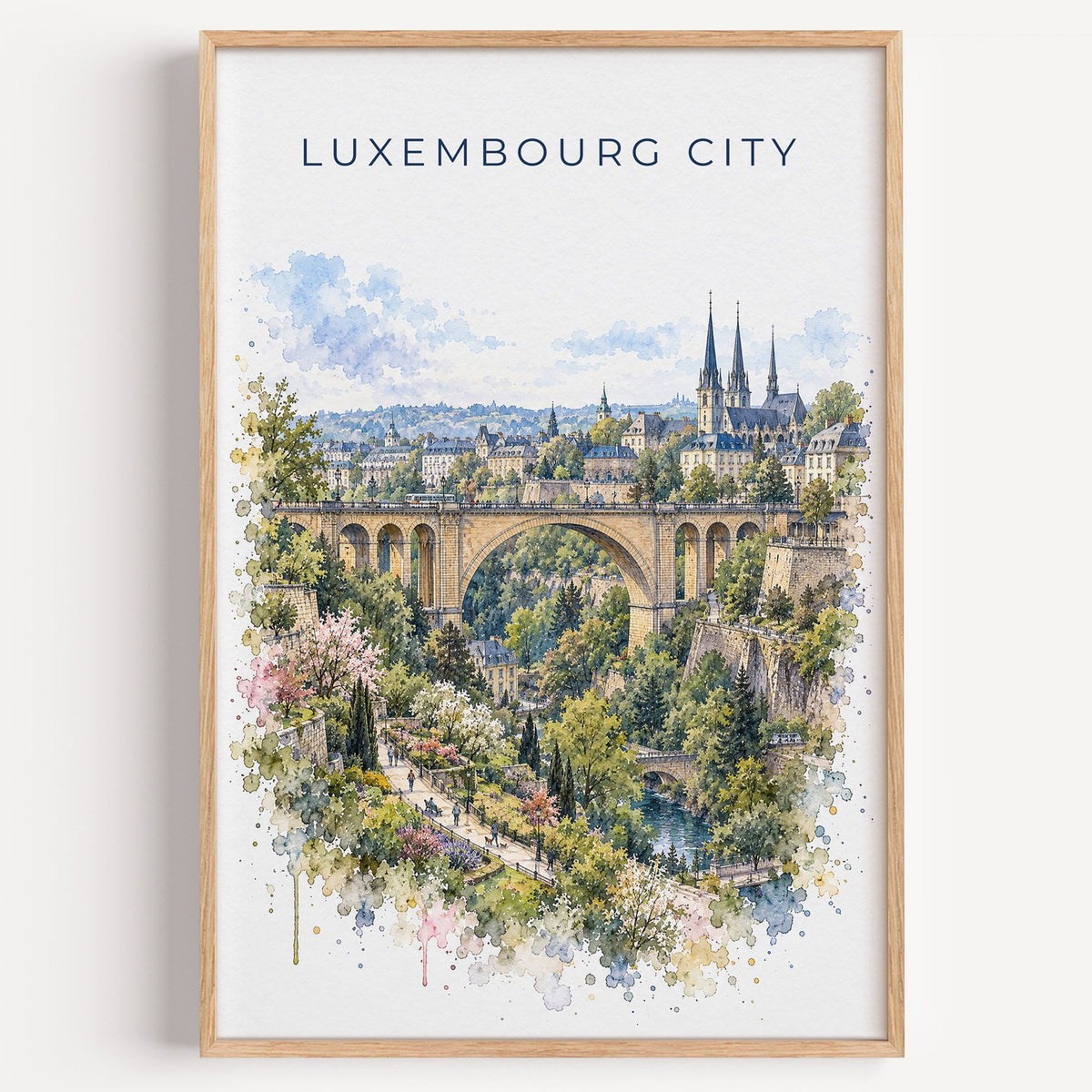 Luxembourg City watercolor print in a light oak frame on a plain white wall