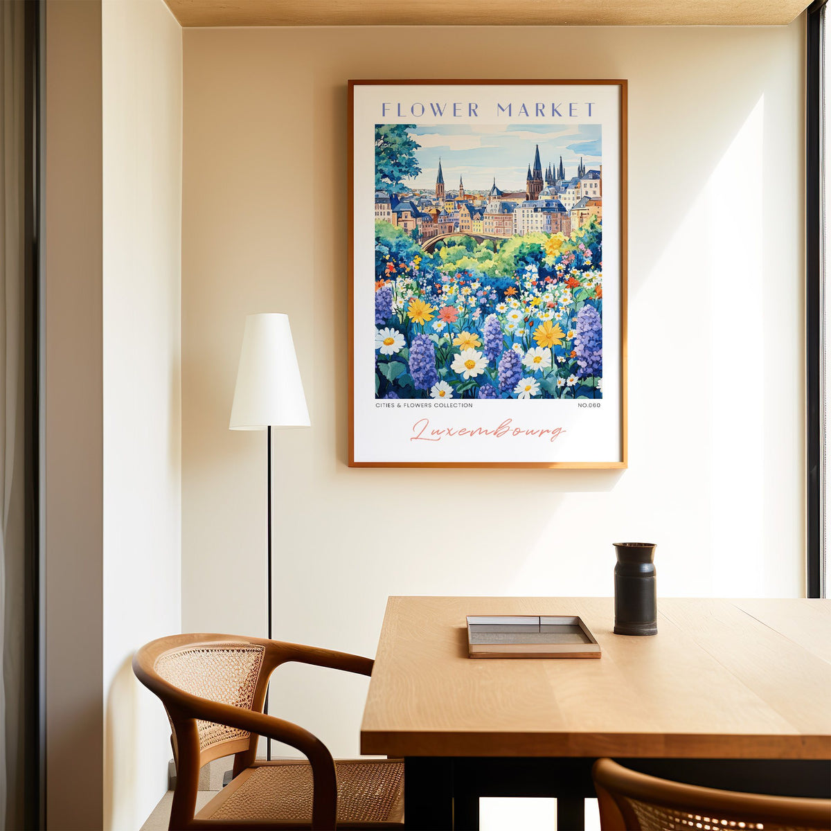 Luxembourg flower market print in an oak frame above a dining table and cane chair