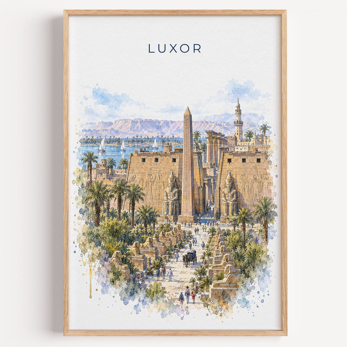 Luxor watercolor print in a light oak frame on a plain white wall