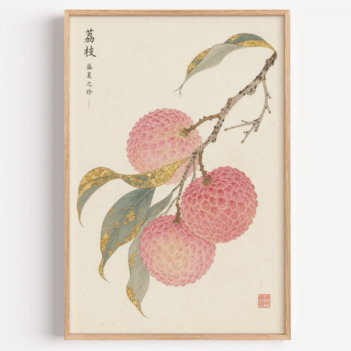 lychee branch with gold-toned leaves print in a light oak frame on a plain white wall