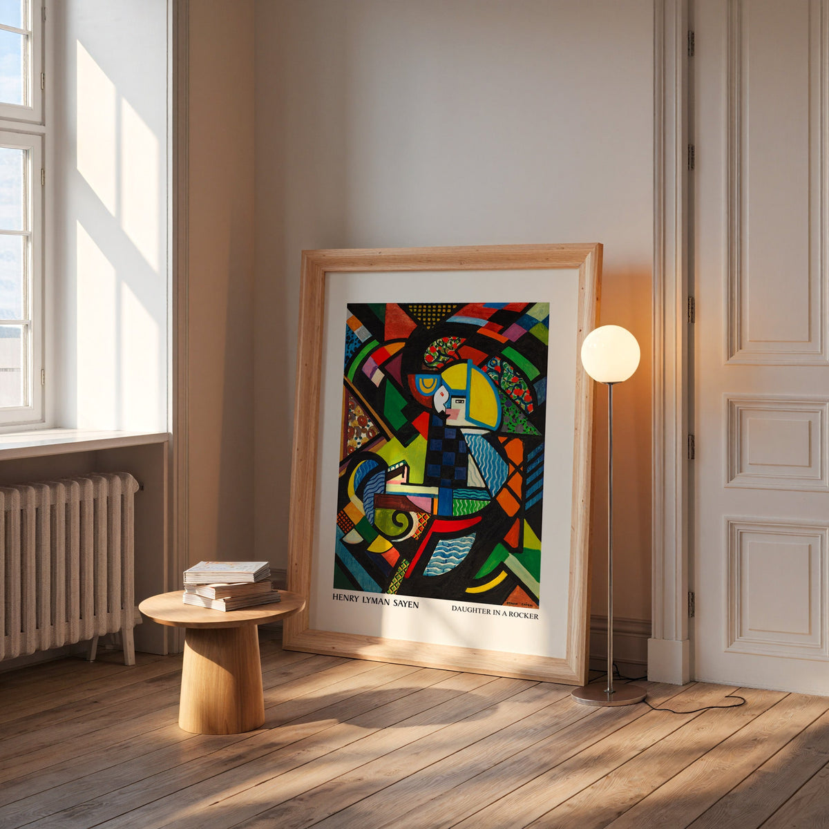 Modern art print in a wide pine frame leaning by a sunlit window