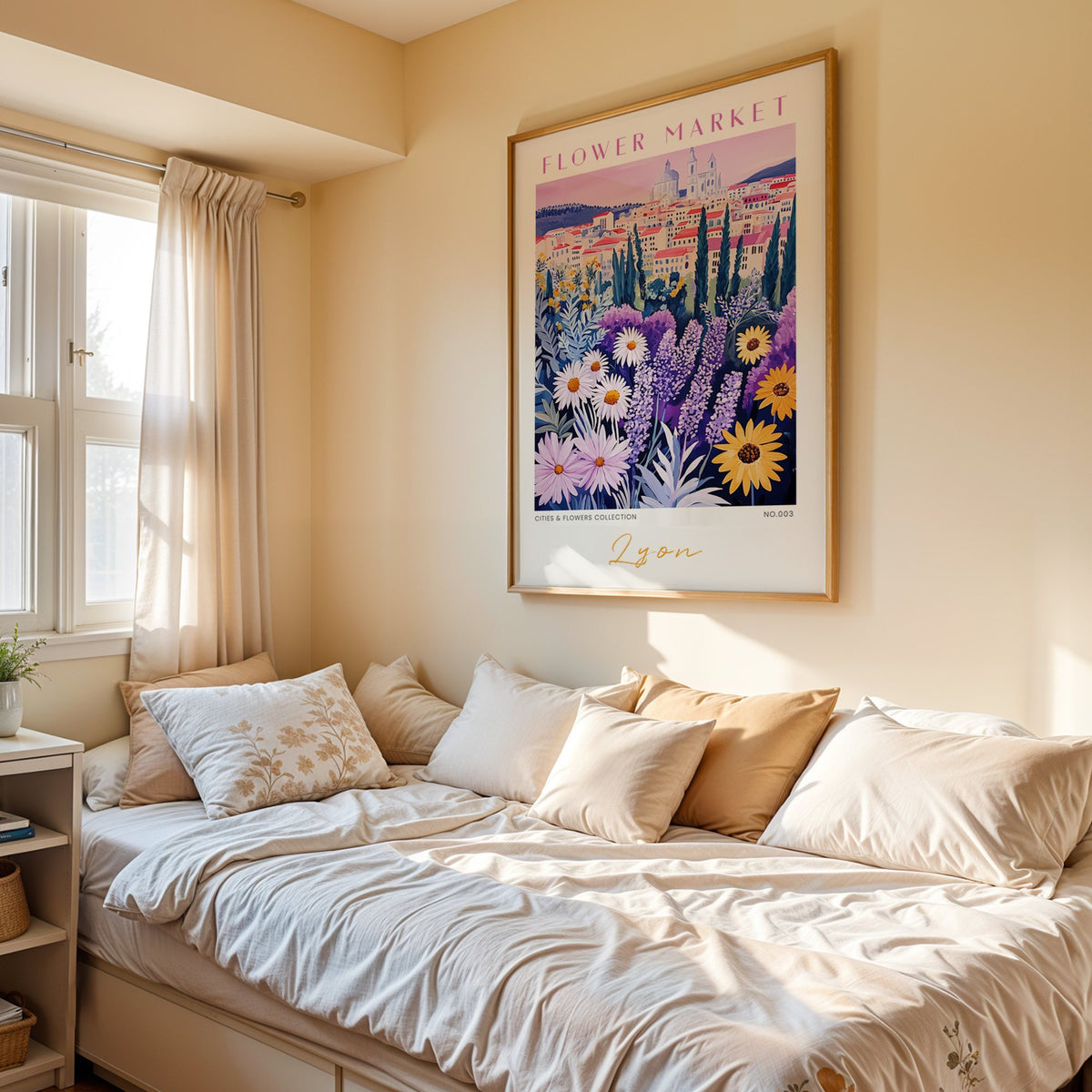 Lyon flower market print in an oak frame above a cream daybed in a sunny bedroom