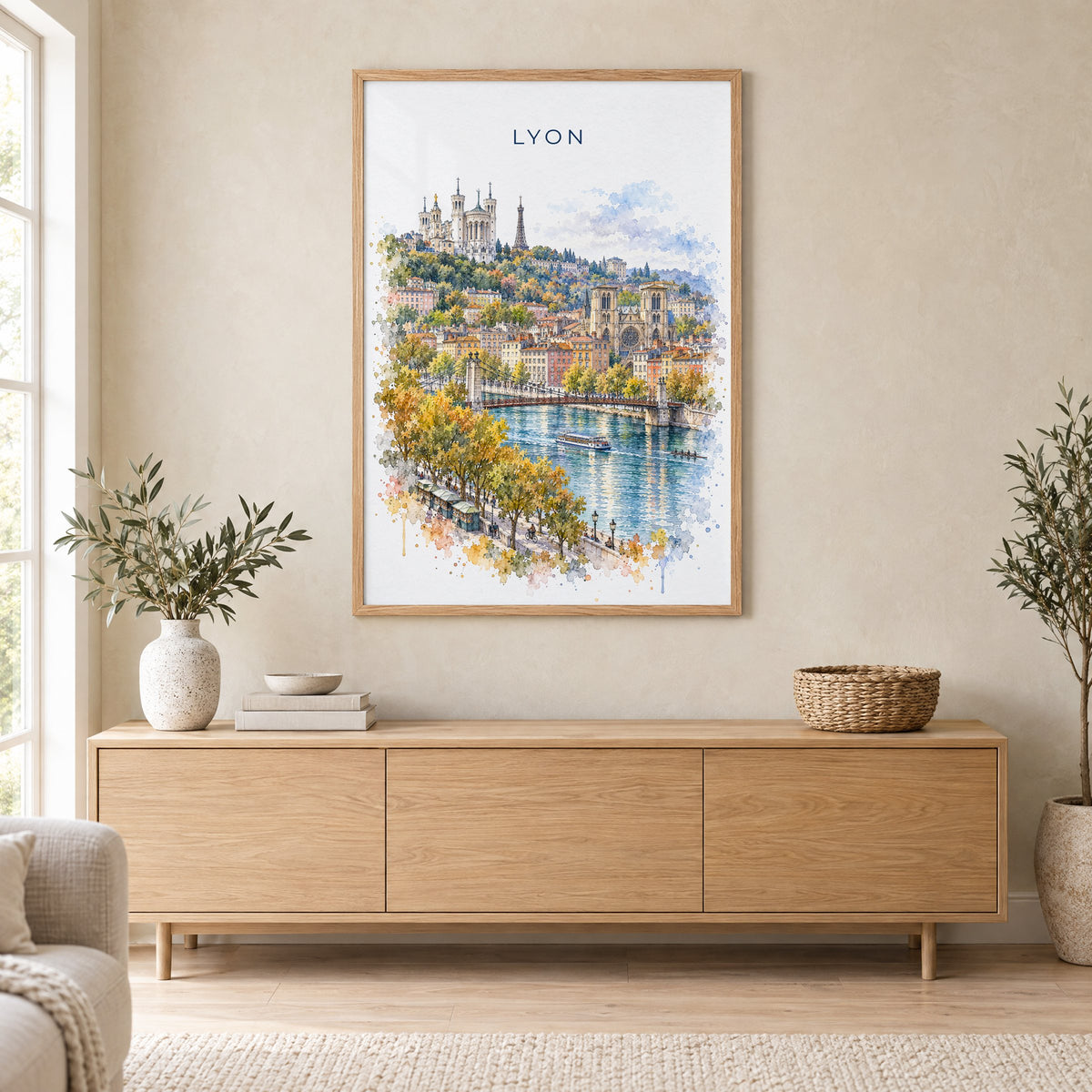 Lyon watercolor print in an oak frame above a light wood sideboard in a Scandinavian living room