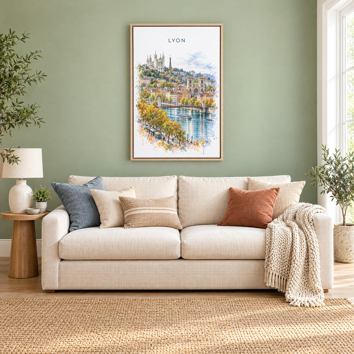 Lyon watercolor print as a natural floater canvas above a cream linen sofa on a sage green wall