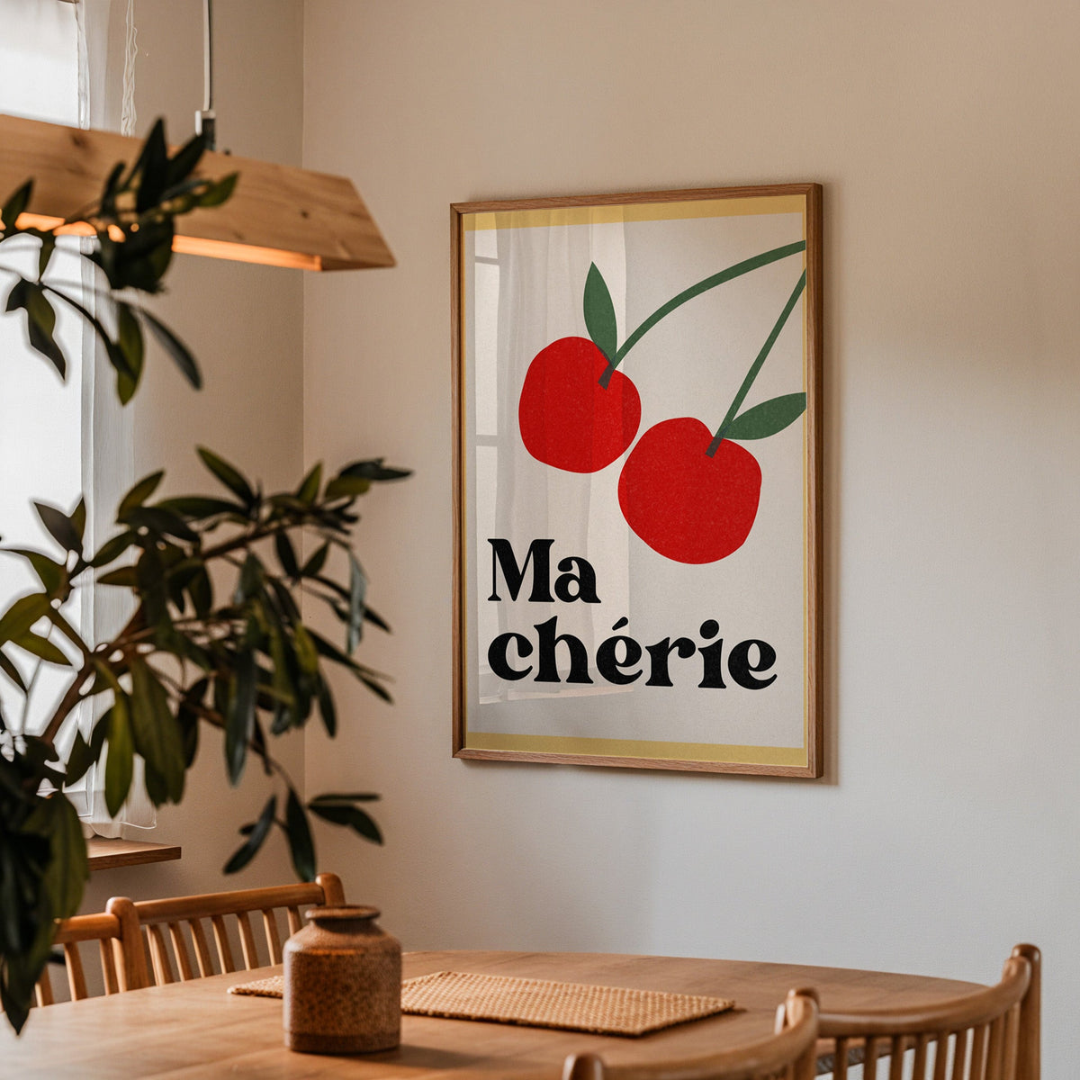 Ma Cherie cherries print in a walnut frame above a dining table with olive branches