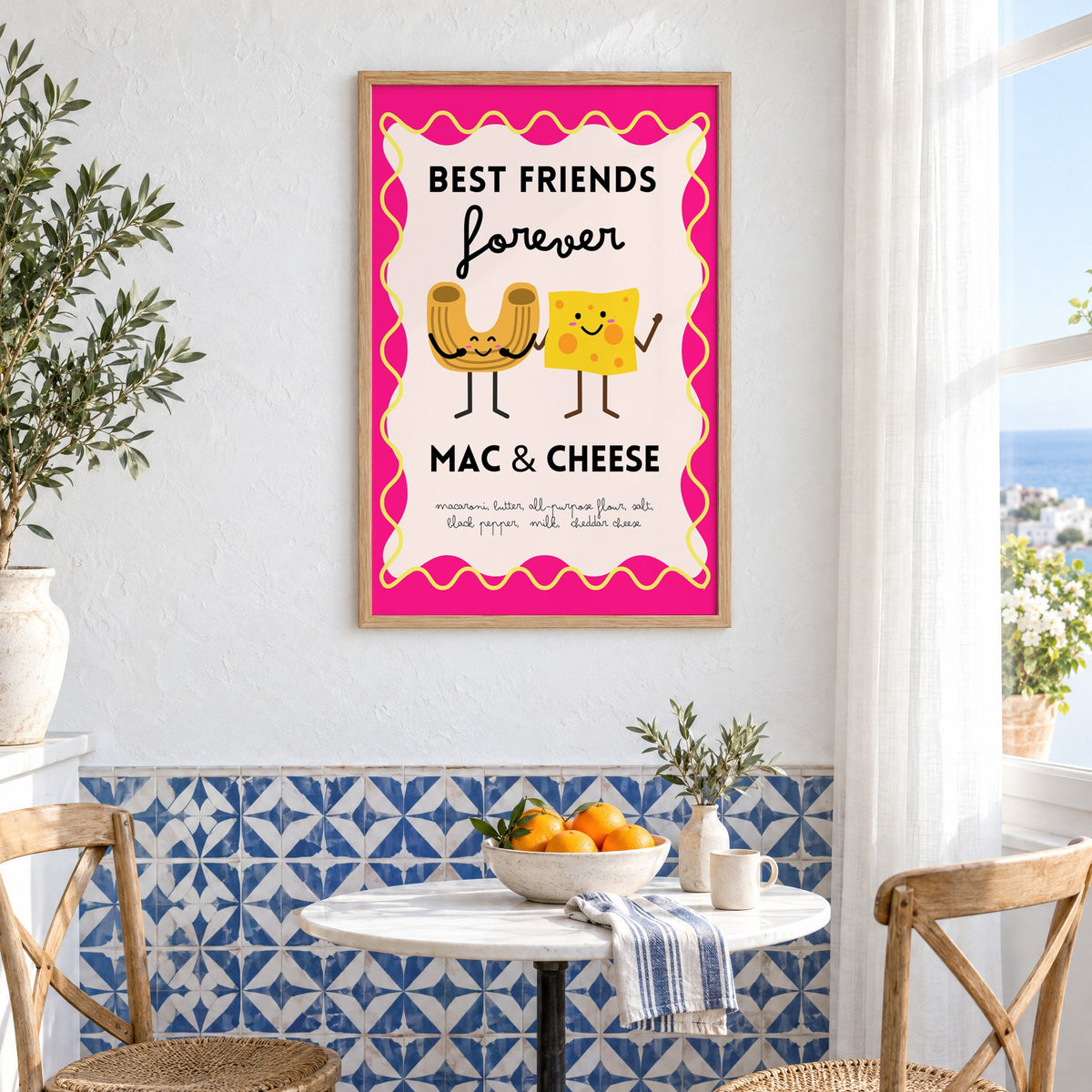 Mac and cheese best friends pink print in an oak frame above a bistro table and blue patterned tiles
