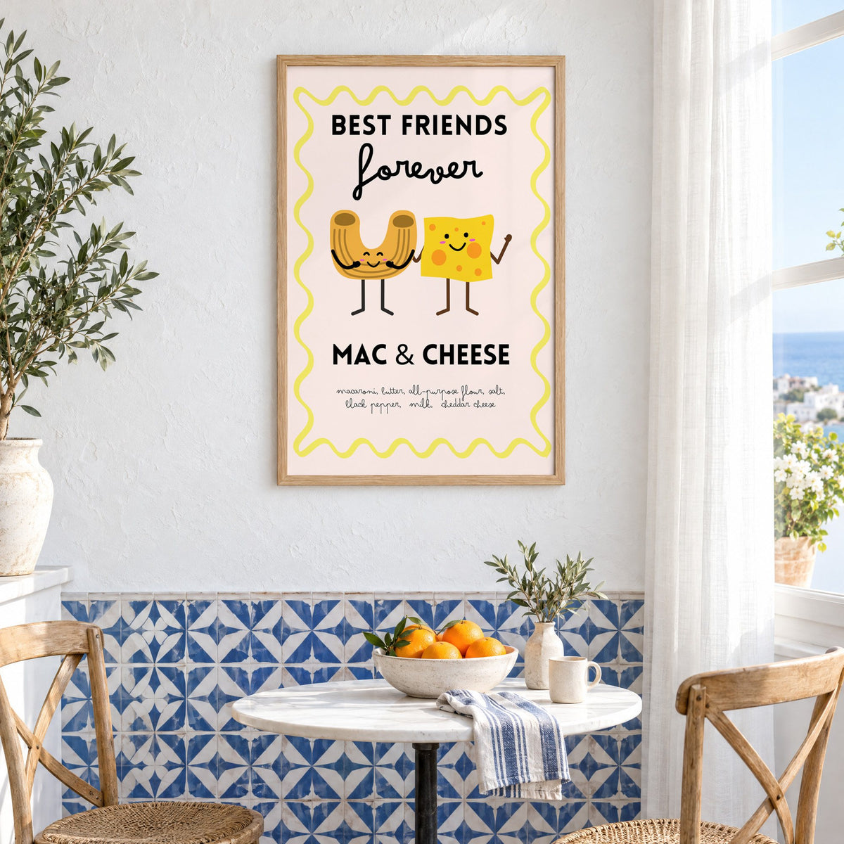 Mac and cheese best friends yellow print in an oak frame above a bistro table and blue patterned tiles