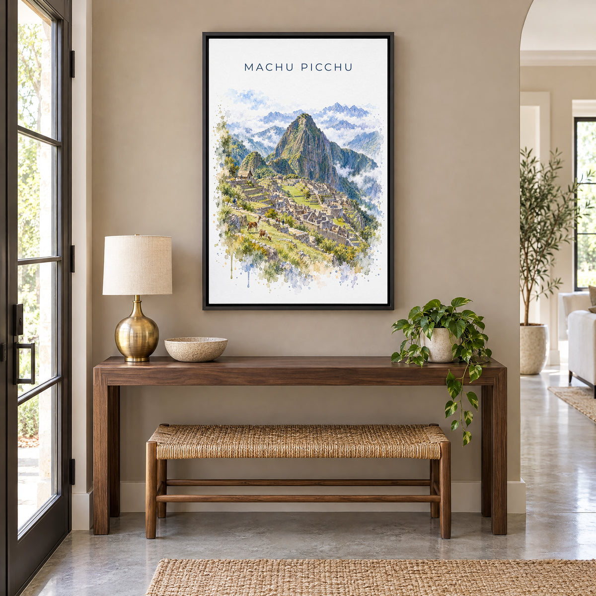 Machu Picchu watercolor print as a black floater canvas above a walnut console and woven bench in an entryway