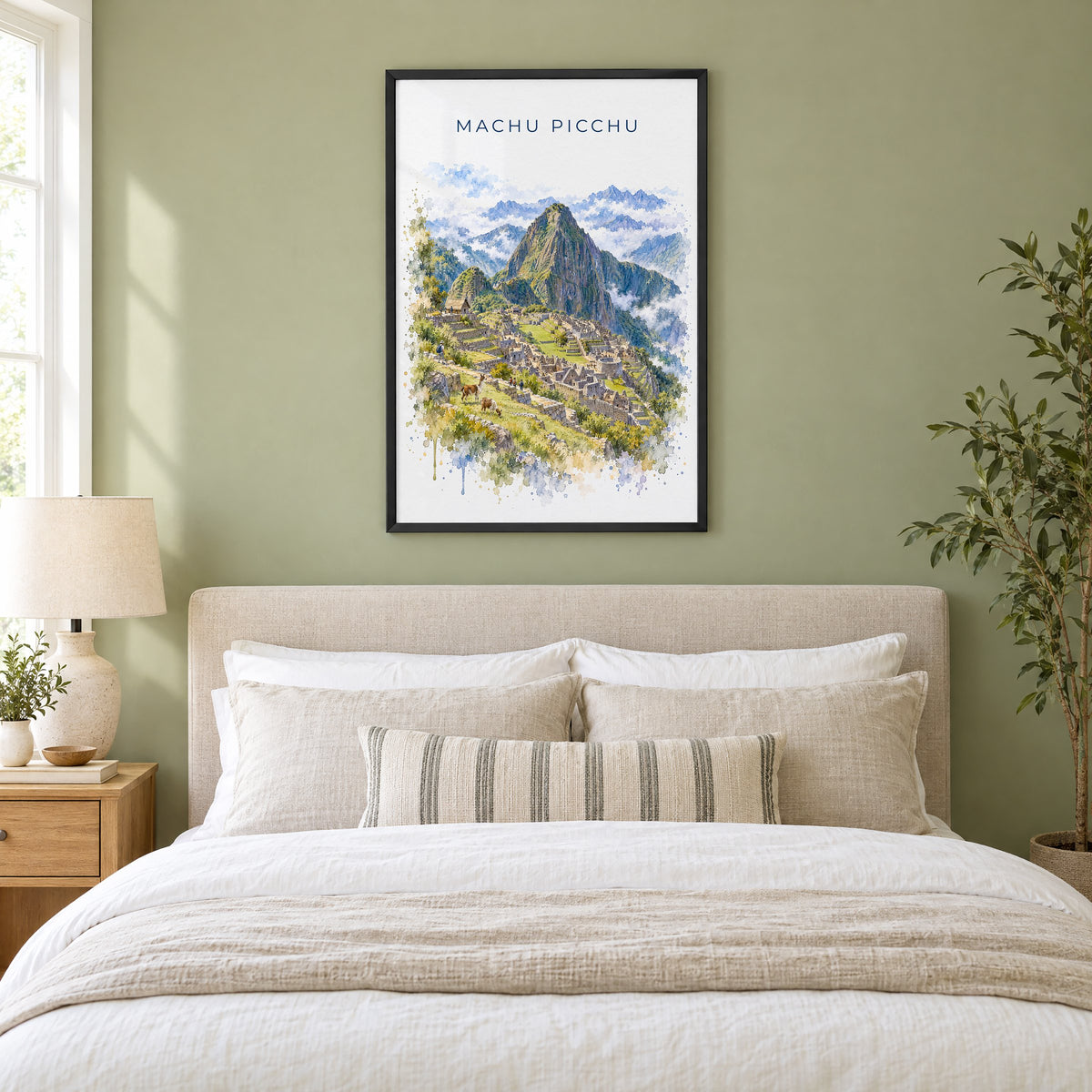 Machu Picchu watercolor print in a black frame above an upholstered headboard in a sage green bedroom