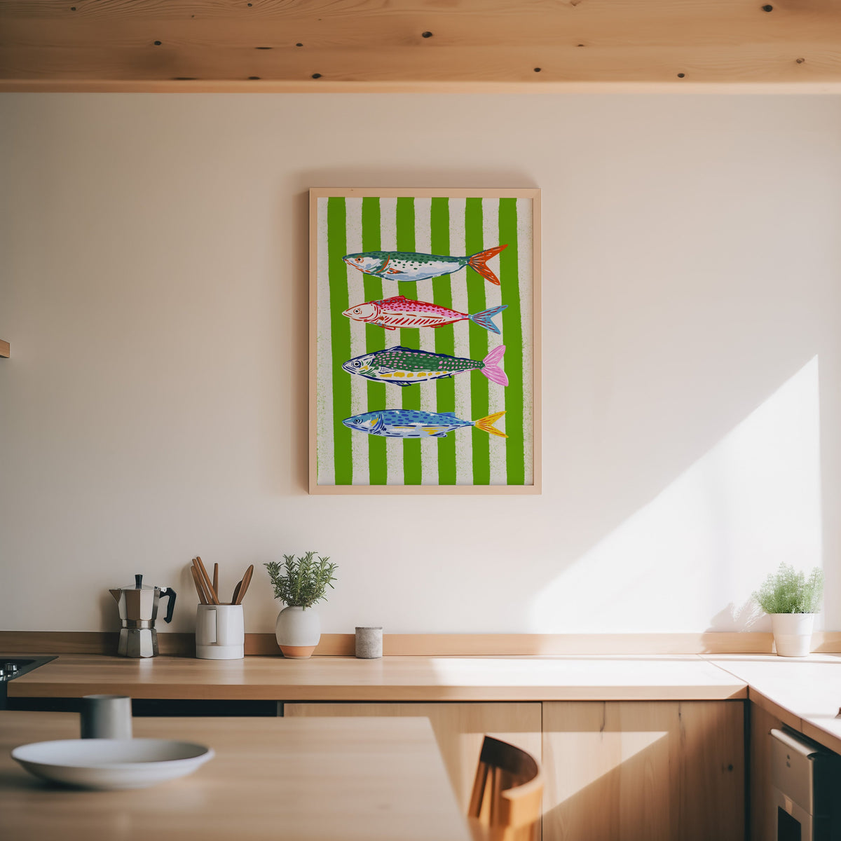 Mackerel row print in an oak frame above a wood counter with a moka pot and herbs