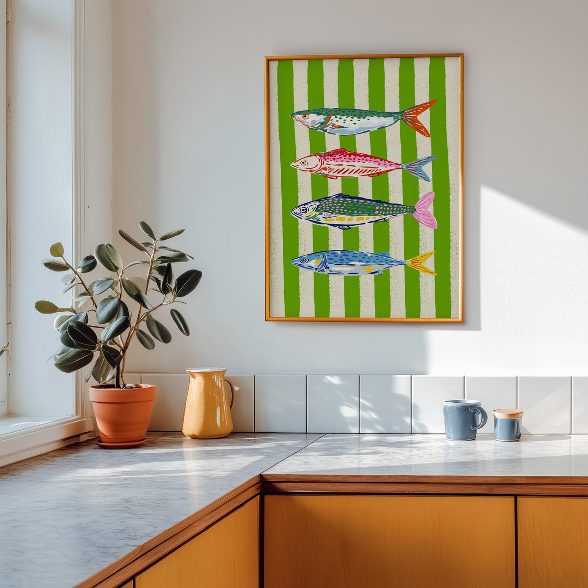 Mackerel row print shown in a gold frame above a marble counter with a yellow ceramic jug