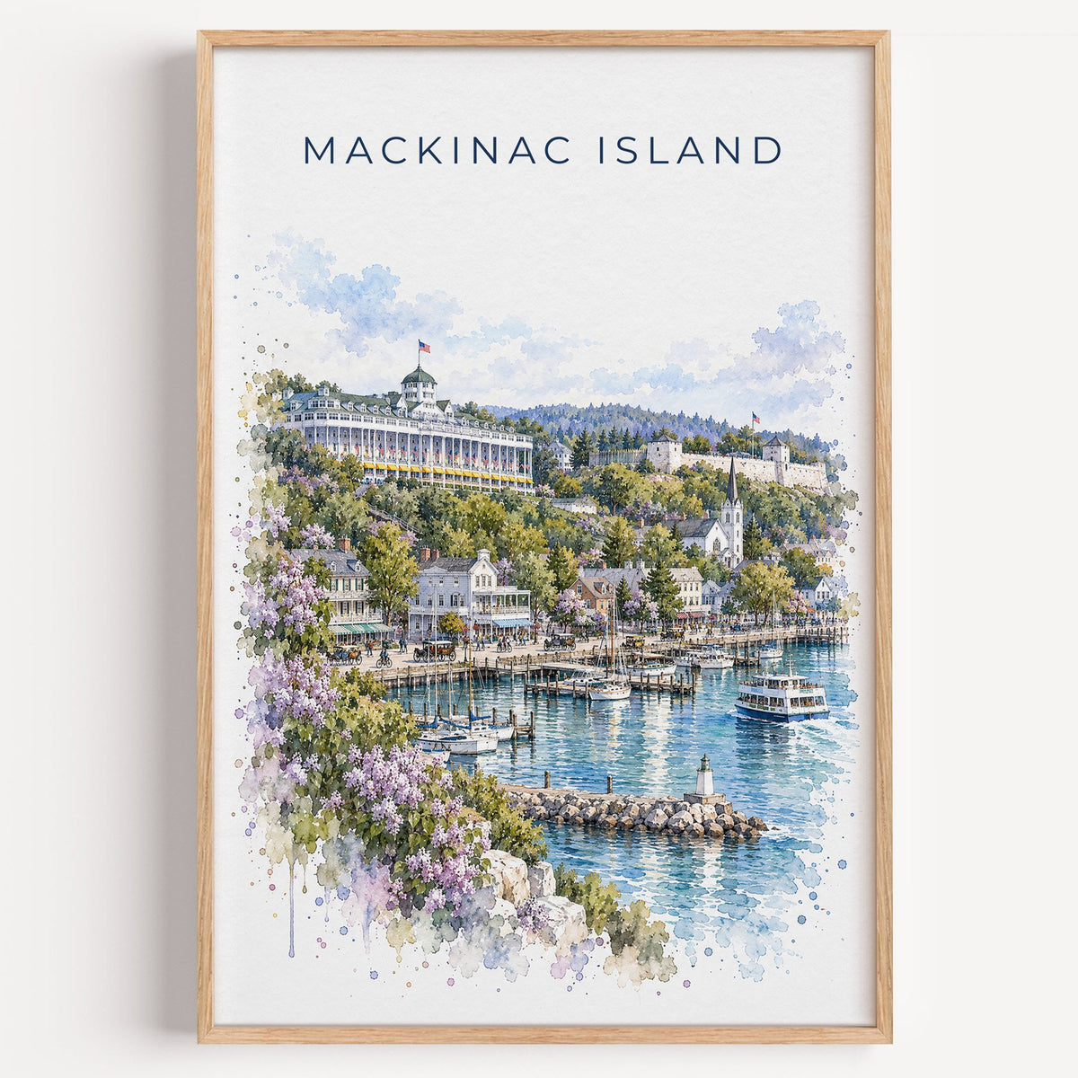 Mackinac Island watercolor print in a light oak frame on a plain white wall