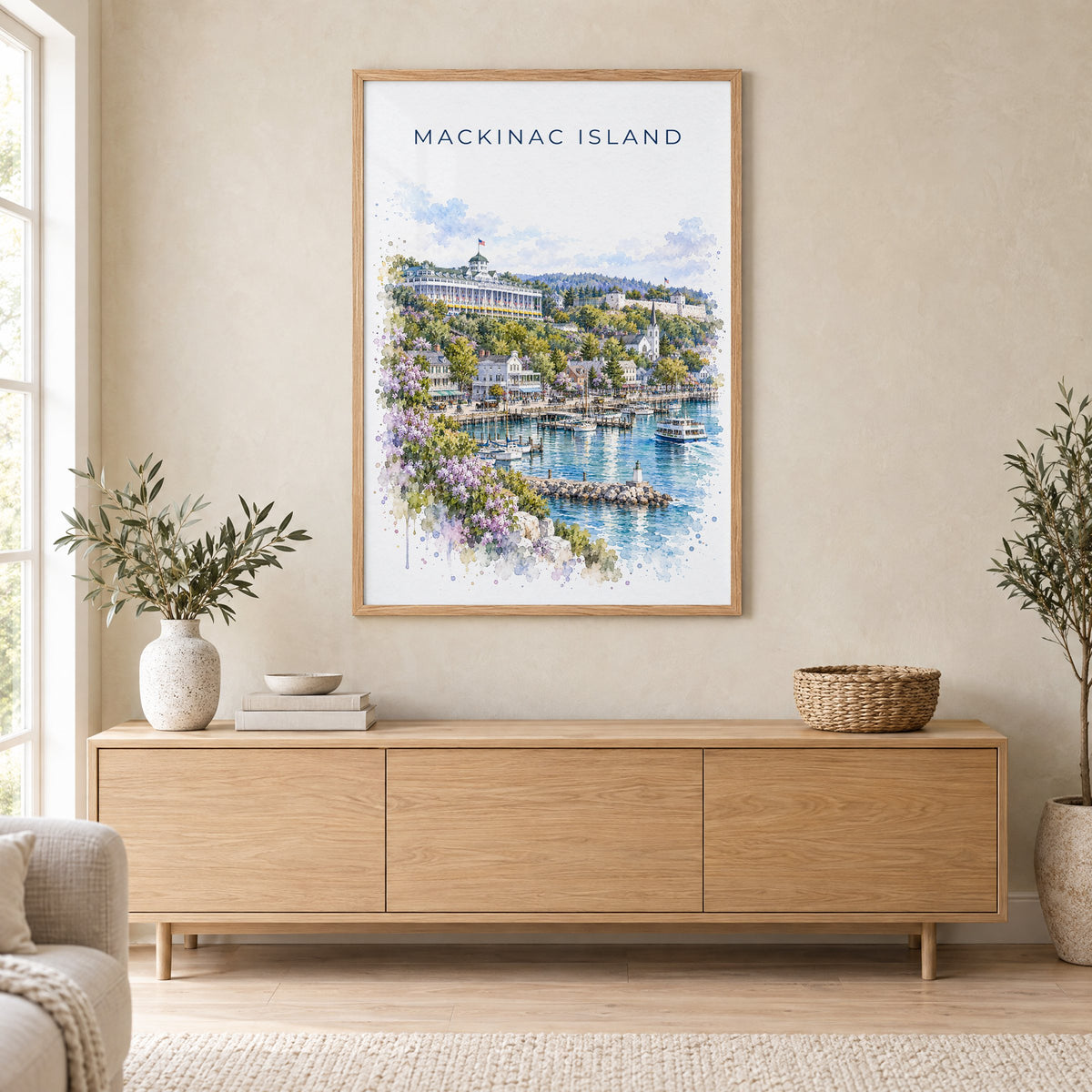 Mackinac Island watercolor print in an oak frame above a light wood sideboard in a Scandinavian living room