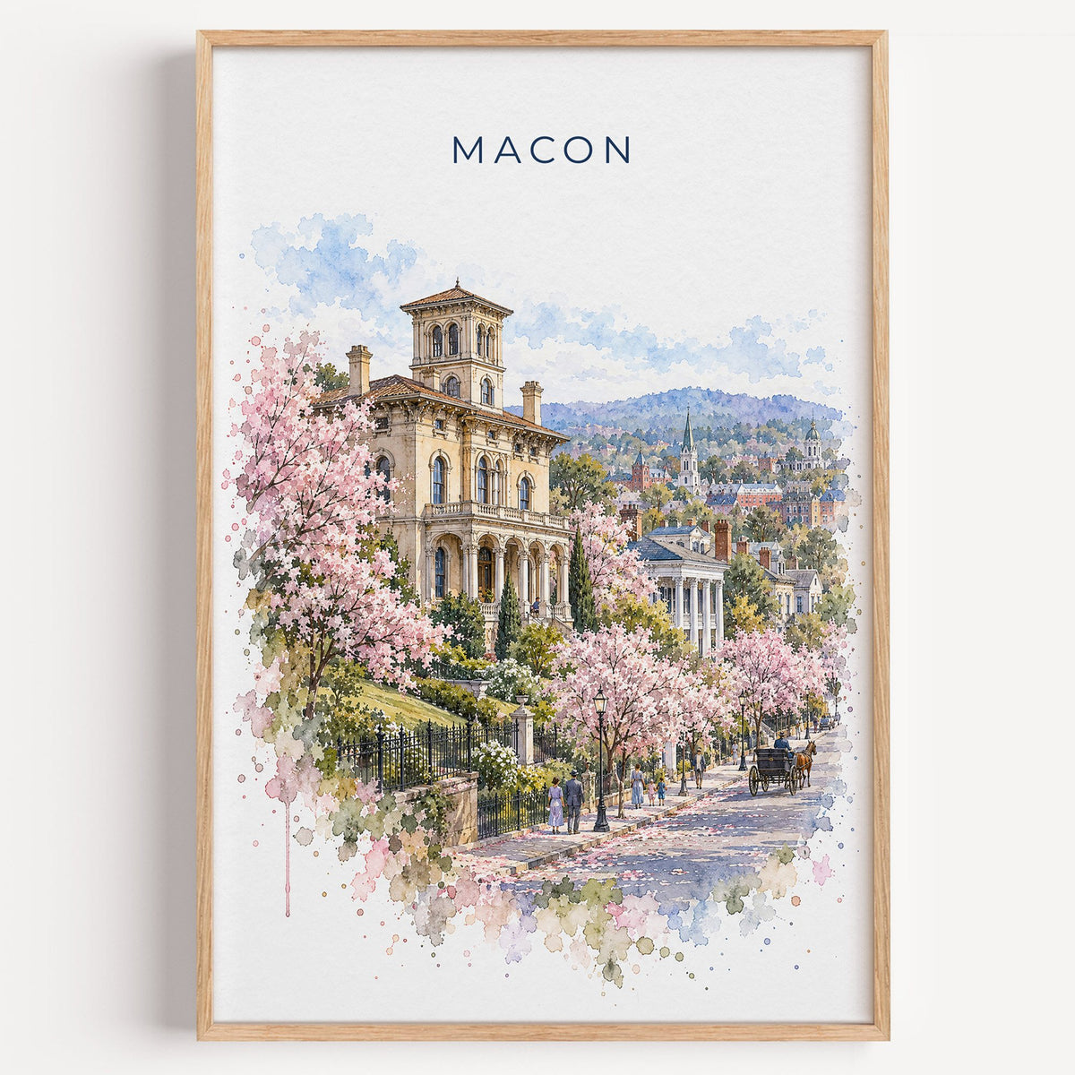 Macon, Georgia watercolor print in a light oak frame on a plain white wall