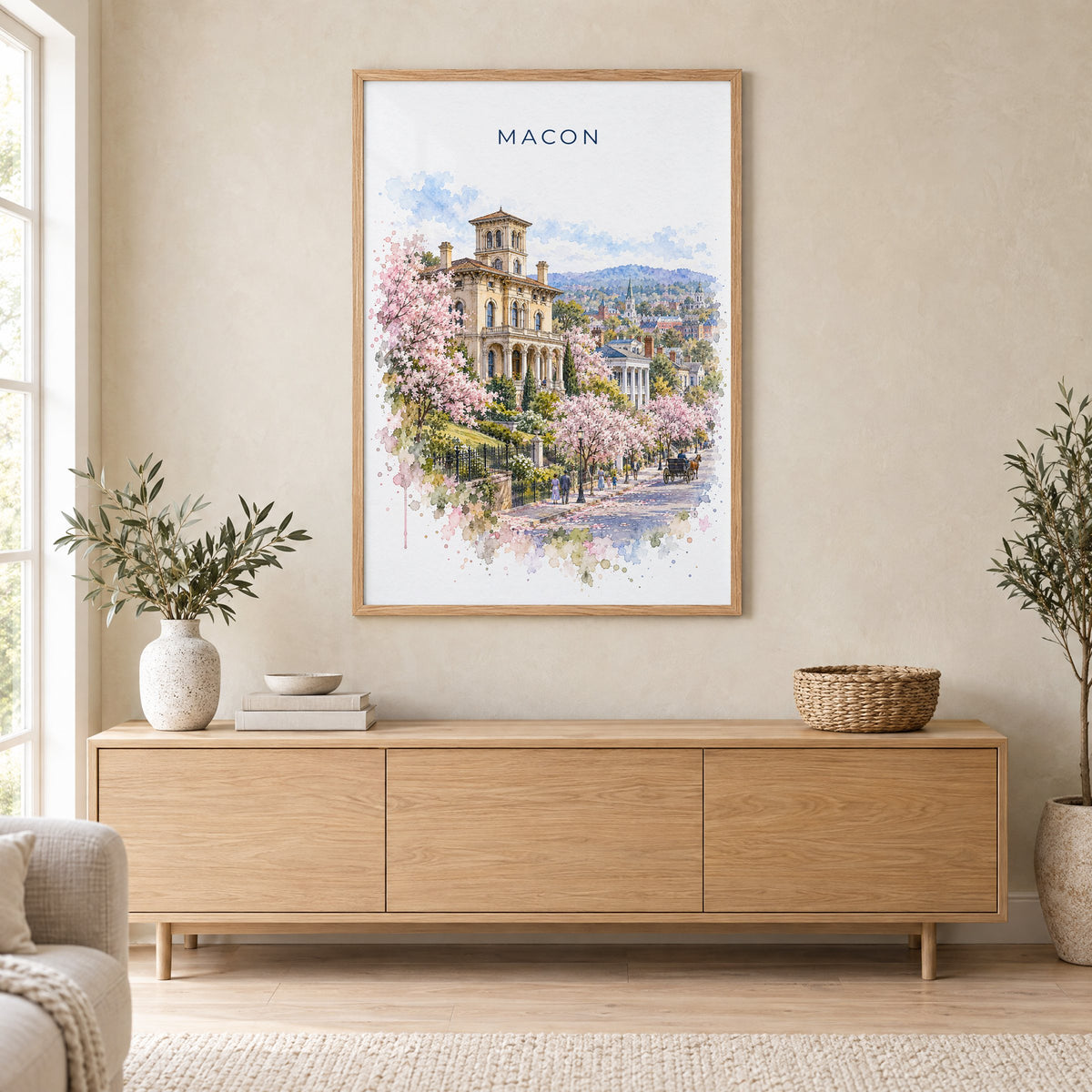 Macon, Georgia watercolor print in an oak frame above a light wood sideboard in a Scandinavian living room