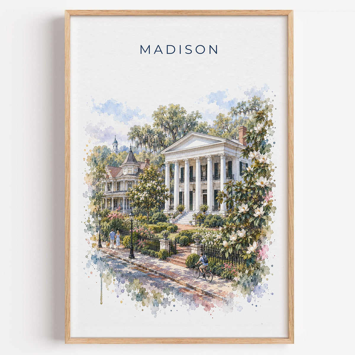 Madison, Georgia watercolor print in a light oak frame on a plain white wall