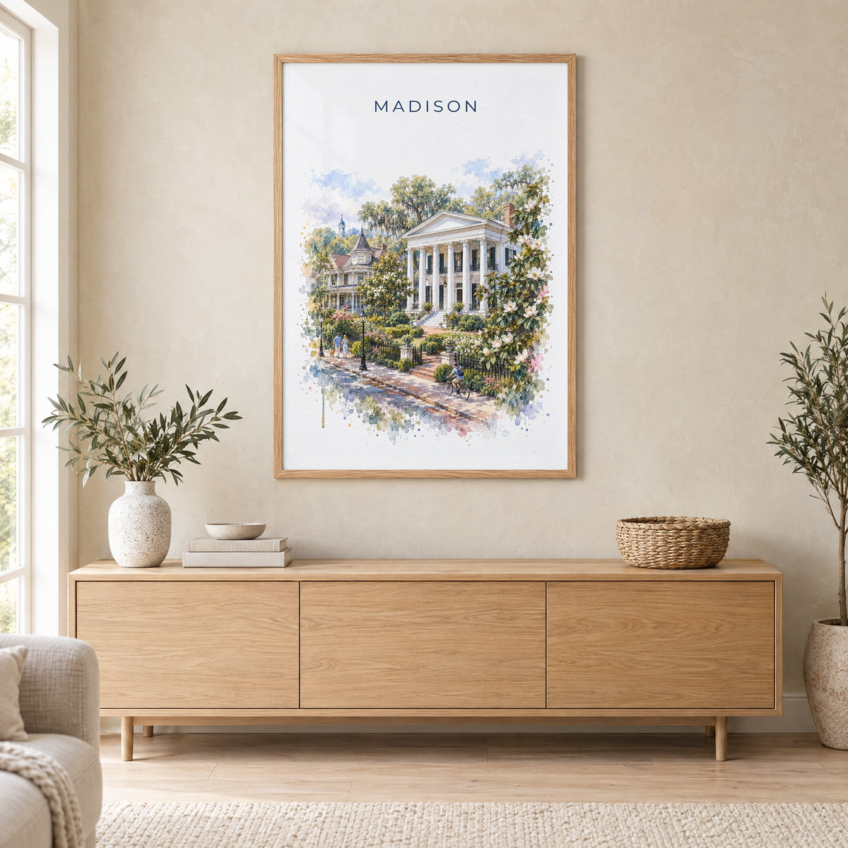 Madison, Georgia watercolor print in an oak frame above a light wood sideboard in a Scandinavian living room