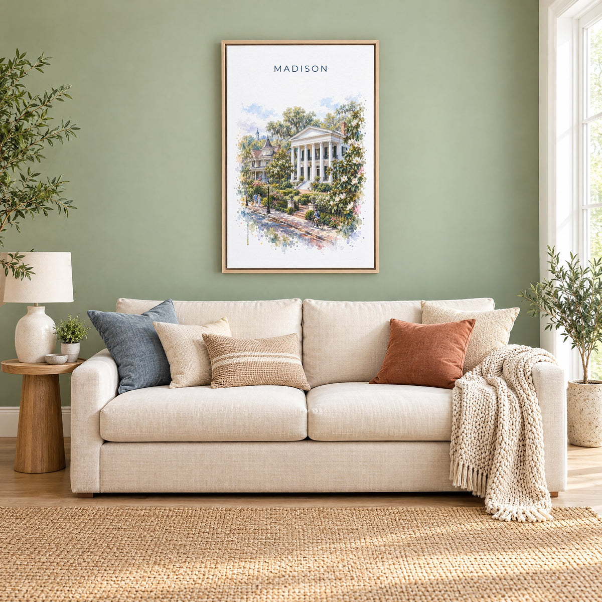 Madison, Georgia watercolor print as a natural floater canvas above a cream linen sofa on a sage green wall