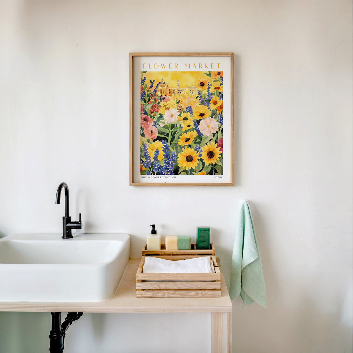Madrid flower market print in an oak frame above a white bathroom sink with folded towels