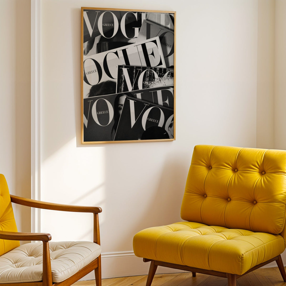 Overlapping magazine covers with giant lettering print shown in a gold frame above a mustard yellow tufted armchair