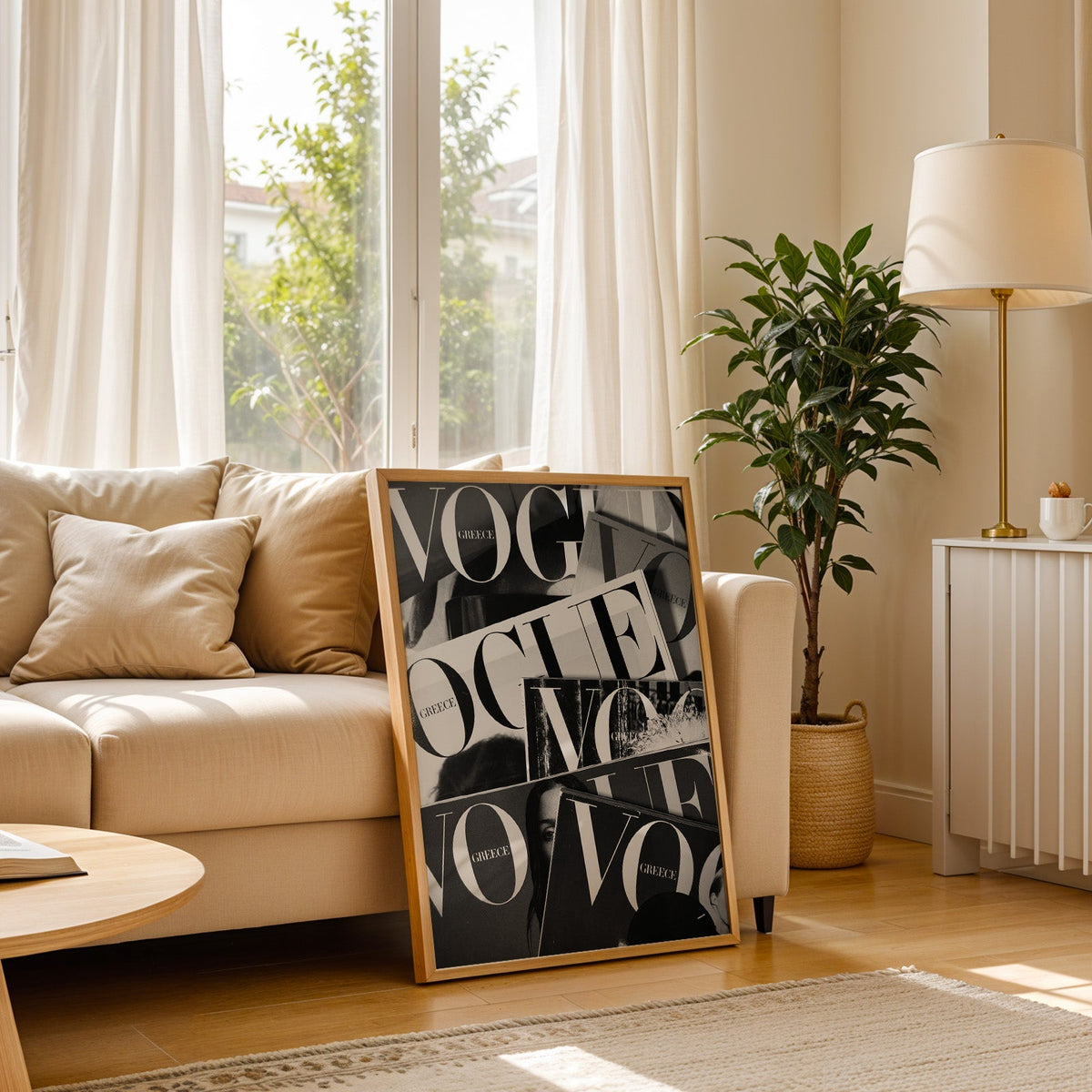 Overlapping magazine covers with giant lettering print in a light oak frame leaning on a cream sofa beside a floor lamp