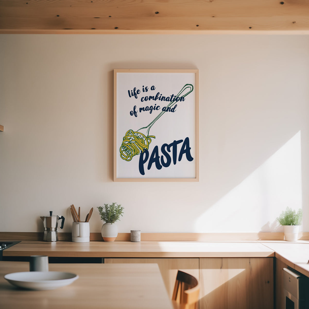 Magic and Pasta print in an oak frame above a wood counter with a moka pot and herbs