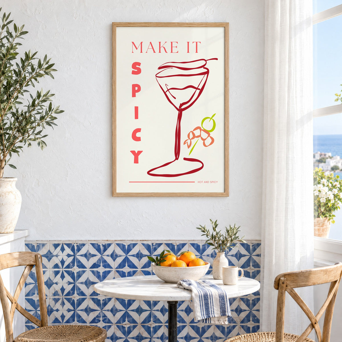 Make It Spicy martini line art print in an oak frame above a bistro table and blue patterned tiles