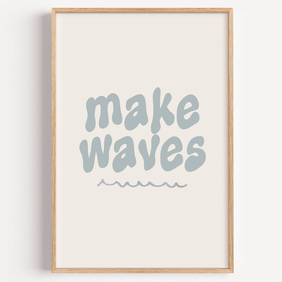 Make waves typography nursery print in a light oak frame on a plain white wall