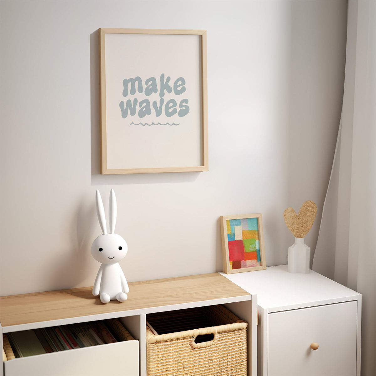 Make waves typography nursery print in an oak frame above a kids cubby shelf with a woven basket and bunny lamp