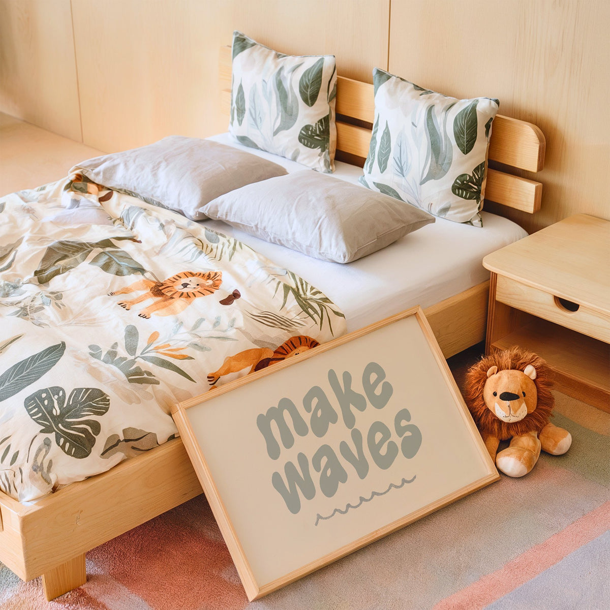 Landscape make waves typography nursery print in an oak frame leaning on a kids bed by a lion plush