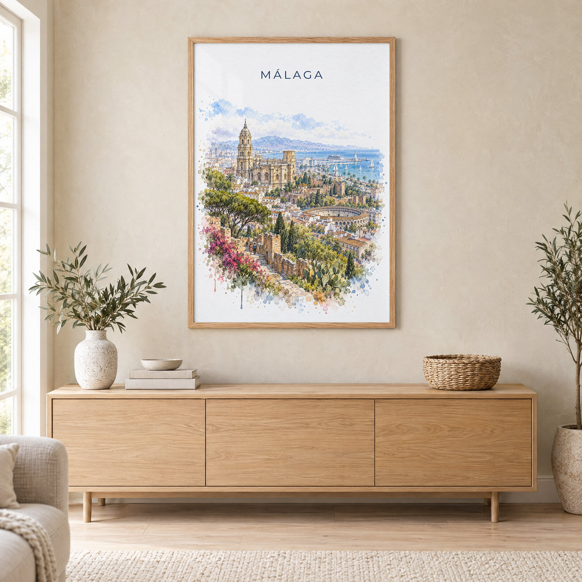 Málaga watercolor print in an oak frame above a light wood sideboard in a Scandinavian living room