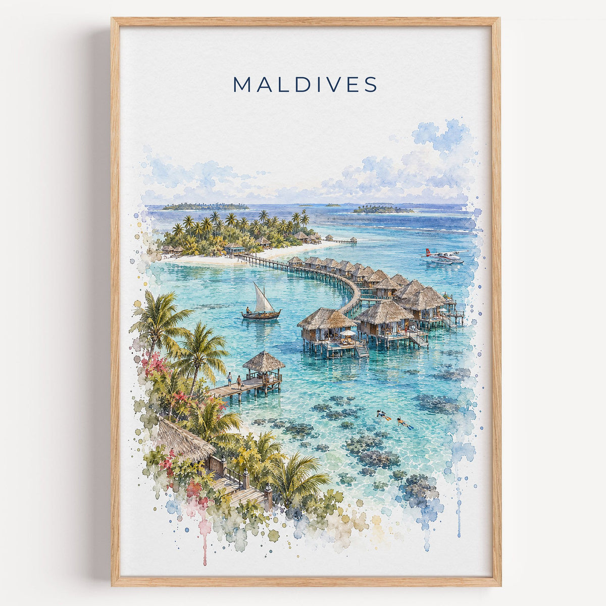Maldives watercolor print in a light oak frame on a plain white wall