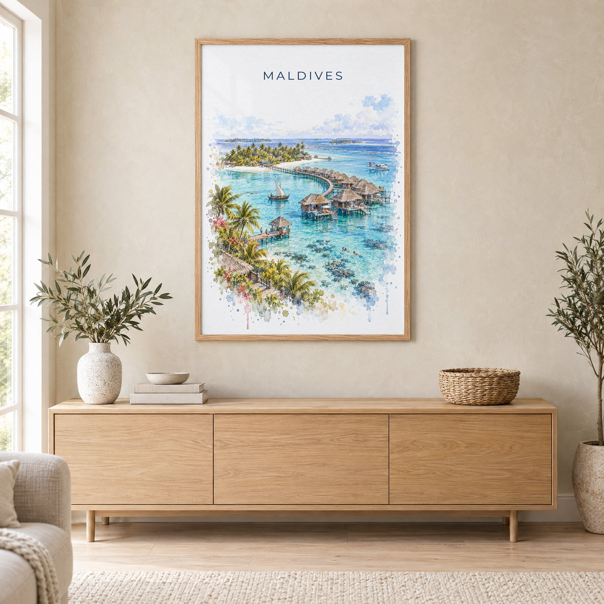 Maldives watercolor print in an oak frame above a light wood sideboard in a Scandinavian living room