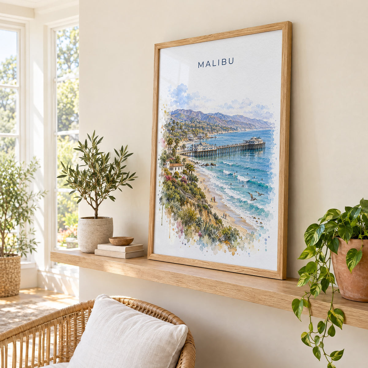 Malibu watercolor print in an oak frame on a picture ledge in a sunlit sunroom